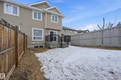 Snow covered house featuring a fenced backyard and a deck - 1349 Cunningham Drive, Edmonton, AB - Outdoor