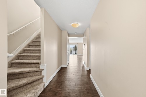 Hallway featuring stairway and dark wood finished floors - 1349 Cunningham Drive, Edmonton, AB - Indoor Photo Showing Other Room