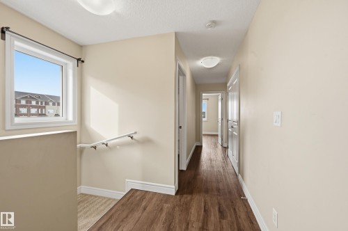 Hall with dark wood-style flooring and a textured ceiling - 1351 Cunningham Drive, Edmonton, AB - Indoor Photo Showing Other Room