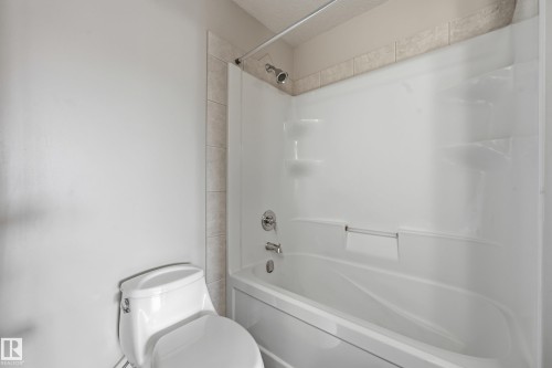 Full bath featuring toilet and shower / washtub combination - 1351 Cunningham Drive, Edmonton, AB - Indoor Photo Showing Bathroom