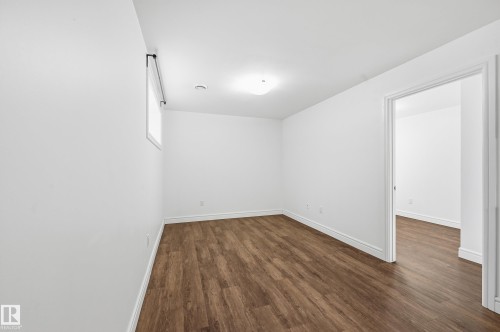 Unfurnished room with dark wood finished floors and baseboards - 1351 Cunningham Drive, Edmonton, AB - Indoor Photo Showing Other Room