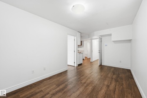 Unfurnished bedroom featuring dark wood-type flooring and baseboards - 1351 Cunningham Drive, Edmonton, AB - Indoor Photo Showing Other Room