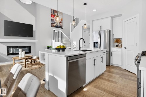 324 Stiles Way, Leduc, AB - Indoor Photo Showing Kitchen With Fireplace With Upgraded Kitchen