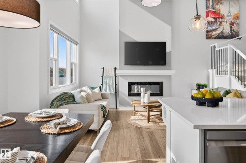 324 Stiles Way, Leduc, AB - Indoor Photo Showing Dining Room With Fireplace