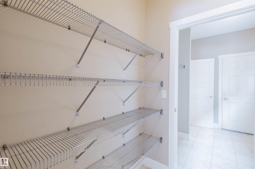 View of walk in closet - 1957 Ainslie Link, Edmonton, AB - Indoor With Storage