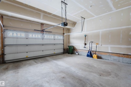 Garage featuring a garage door opener - 1957 Ainslie Link, Edmonton, AB - Indoor Photo Showing Garage