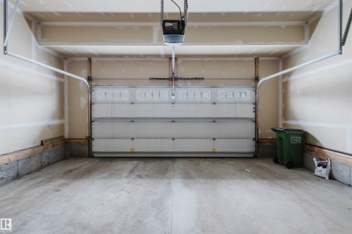 Garage featuring a garage door opener - 1957 Ainslie Link, Edmonton, AB - Indoor Photo Showing Garage