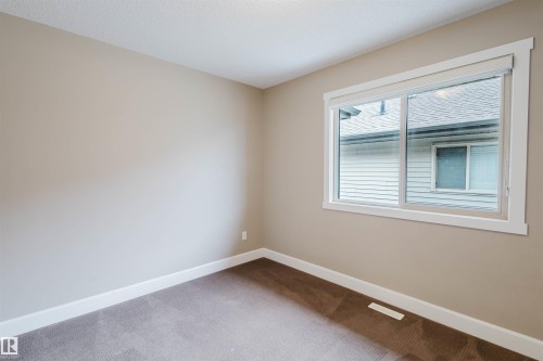 Unfurnished room with baseboards and light carpet - 1957 Ainslie Link, Edmonton, AB - Indoor Photo Showing Other Room