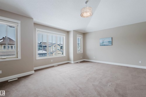 Unfurnished room with baseboards and light colored carpet - 1957 Ainslie Link, Edmonton, AB - Indoor Photo Showing Other Room