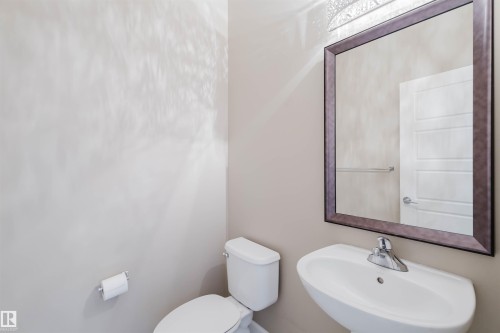 Half bathroom featuring a sink and toilet - 1957 Ainslie Link, Edmonton, AB - Indoor Photo Showing Bathroom