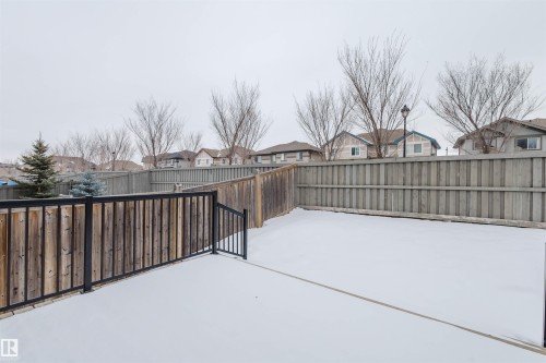 Fenced backyard with a residential view - 1957 Ainslie Link, Edmonton, AB - Outdoor