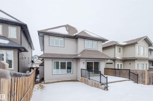 View of front facade featuring roof with shingles, a fenced backyard, and a deck - 1957 Ainslie Link, Edmonton, AB - Outdoor