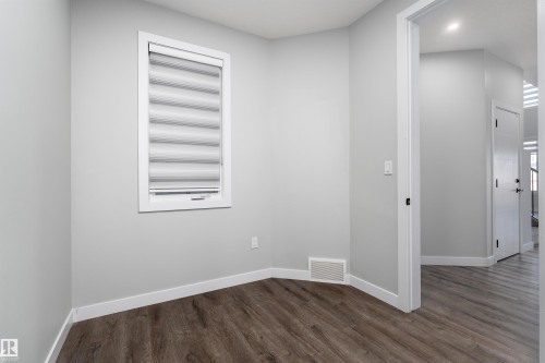 Spare room featuring dark wood-style flooring and recessed lighting - 5211 Kimball Crescent, Edmonton, AB - Indoor Photo Showing Other Room
