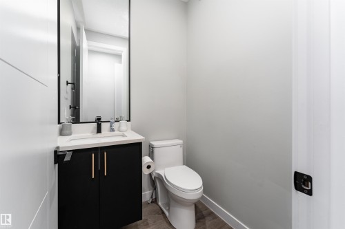 Half bath featuring vanity and dark wood-type flooring - 5211 Kimball Crescent, Edmonton, AB - Indoor Photo Showing Bathroom