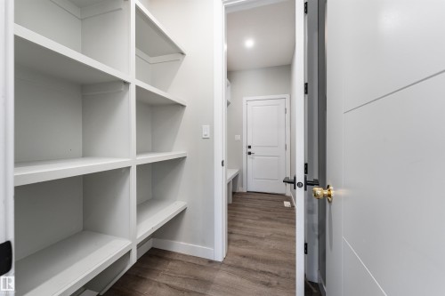 Hall featuring dark wood-style floors and baseboards - 5211 Kimball Crescent, Edmonton, AB - Indoor With Storage
