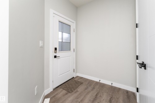 Doorway with baseboards and wood finished floors - 5211 Kimball Crescent, Edmonton, AB - Indoor Photo Showing Other Room