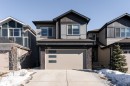 Craftsman-style house featuring stone siding, concrete driveway, a garage, board and batten siding, and a shingled roof - 5211 Kimball Crescent, Edmonton, AB  - Outdoor With Facade 