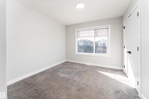 Unfurnished bedroom featuring a closet and carpet flooring - 5211 Kimball Crescent, Edmonton, AB - Indoor Photo Showing Other Room