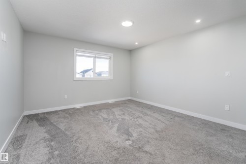 Empty room with light carpet and recessed lighting - 5211 Kimball Crescent, Edmonton, AB - Indoor Photo Showing Other Room