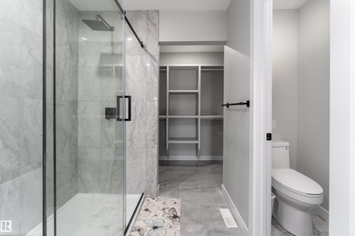 Full bathroom featuring a spacious closet and a marble finish shower - 5211 Kimball Crescent, Edmonton, AB - Indoor Photo Showing Bathroom