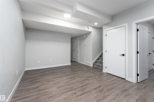 Finished below grade area with light wood-style flooring and recessed lighting - 5211 Kimball Crescent, Edmonton, AB - Indoor Photo Showing Other Room