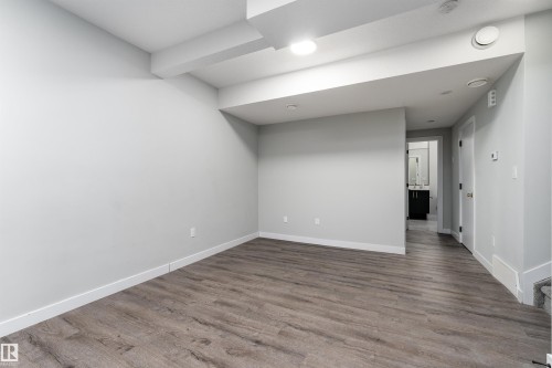 Unfurnished room with dark wood-style flooring and recessed lighting - 5211 Kimball Crescent, Edmonton, AB - Indoor Photo Showing Other Room