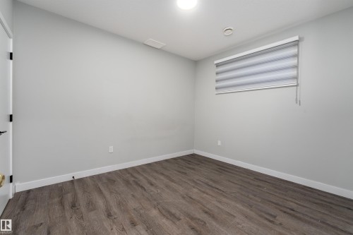 Unfurnished room with dark wood finished floors and baseboards - 5211 Kimball Crescent, Edmonton, AB - Indoor Photo Showing Other Room