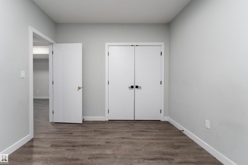 Unfurnished bedroom featuring dark wood finished floors and a closet - 5211 Kimball Crescent, Edmonton, AB - Indoor Photo Showing Other Room