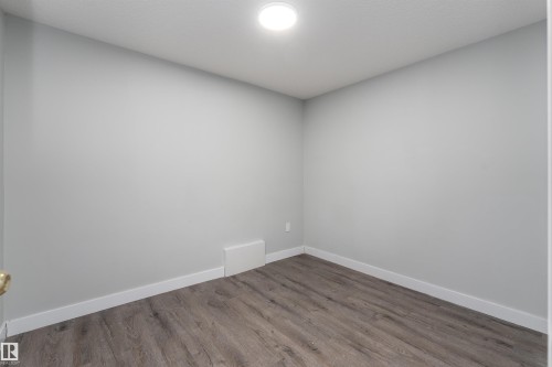 Spare room with baseboards and dark wood finished floors - 5211 Kimball Crescent, Edmonton, AB - Indoor Photo Showing Other Room