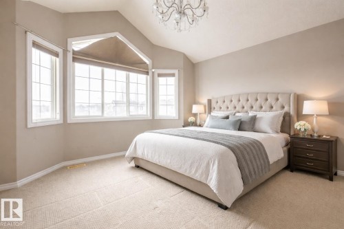 Bedroom featuring a chandelier, lofted ceiling, and light colored carpet - 11622 11 Avenue, Edmonton, AB - Indoor Photo Showing Bedroom