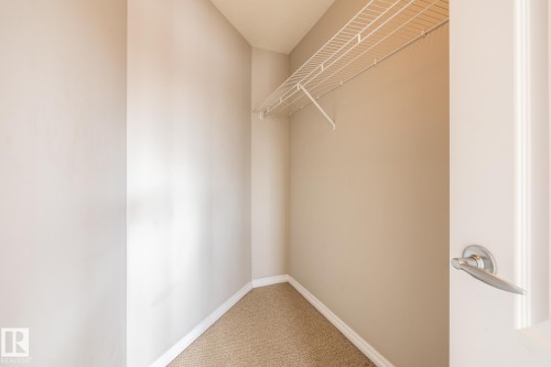Walk in closet featuring light colored carpet - 11622 11 Avenue, Edmonton, AB - Indoor