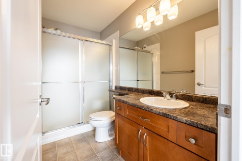 Full bath with vanity, a shower stall, and light tile patterned flooring - 11622 11 Avenue, Edmonton, AB - Indoor Photo Showing Bathroom