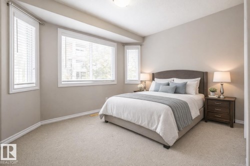 Bedroom with light carpet and baseboards - 11622 11 Avenue, Edmonton, AB - Indoor Photo Showing Bedroom
