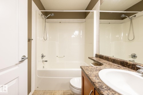 Bathroom featuring vanity, tub / shower combination, and light tile patterned floors - 11622 11 Avenue, Edmonton, AB - Indoor Photo Showing Bathroom