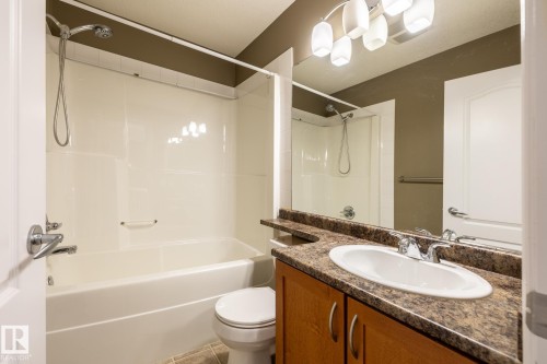 Full bathroom with vanity, bathtub / shower combination, and light tile patterned flooring - 11622 11 Avenue, Edmonton, AB - Indoor Photo Showing Bathroom