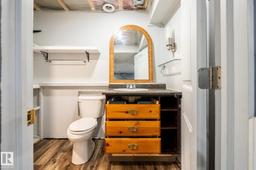 Half bathroom featuring vanity and dark wood-style floors - 11622 11 Avenue, Edmonton, AB - Indoor Photo Showing Bathroom