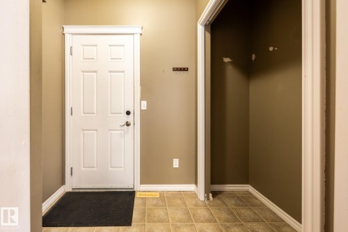 Doorway featuring baseboards and tile patterned flooring - 11622 11 Avenue, Edmonton, AB - Indoor Photo Showing Other Room