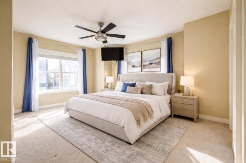 Carpeted bedroom featuring a ceiling fan and baseboards - 21 655 Watt Boulevard, Edmonton, AB - Indoor Photo Showing Bedroom