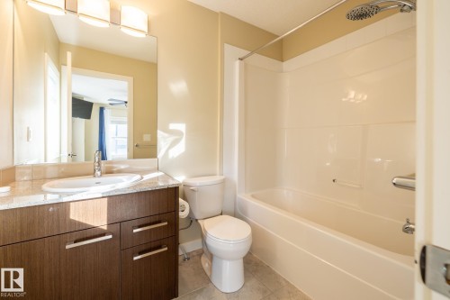 Full bathroom with vanity, light tile patterned flooring, and shower / bathtub combination - 21 655 Watt Boulevard, Edmonton, AB - Indoor Photo Showing Bathroom