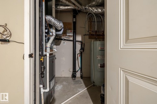 Utility room with water heater and heating unit - 21 655 Watt Boulevard, Edmonton, AB - Indoor Photo Showing Basement