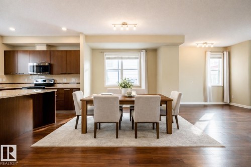 Dining room with dark wood-style flooring and rail lighting - 21 655 Watt Boulevard, Edmonton, AB - Indoor