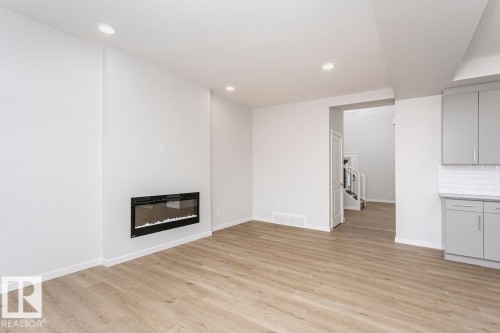 7622 Kimiwan Crescent, Edmonton, AB - Indoor Photo Showing Other Room With Fireplace