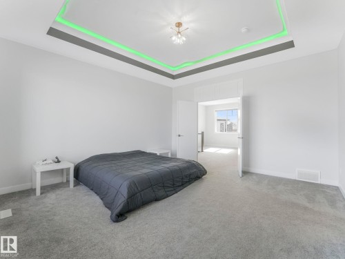 Bedroom featuring carpet floors and a tray ceiling - 1104 152 Avenue, Edmonton, AB - Indoor Photo Showing Bedroom