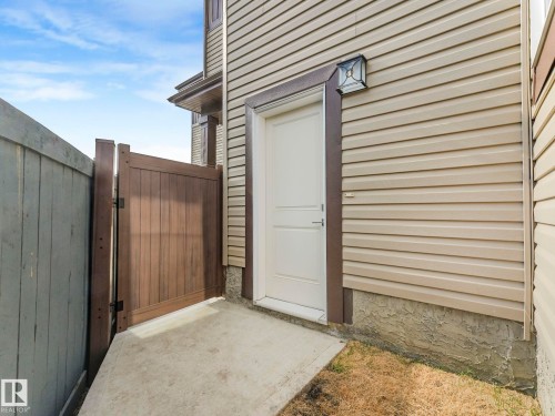 Doorway to property with a gate and a patio area - 1104 152 Avenue, Edmonton, AB - Outdoor With Exterior