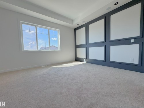Carpeted spare room featuring baseboards - 7 Tilia Place, Spruce Grove, AB - Indoor Photo Showing Other Room