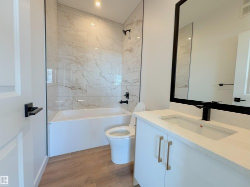 Full bath featuring vanity,  shower combination, light wood-type flooring, and recessed lighting - 7 Tilia Place, Spruce Grove, AB - Indoor Photo Showing Bathroom
