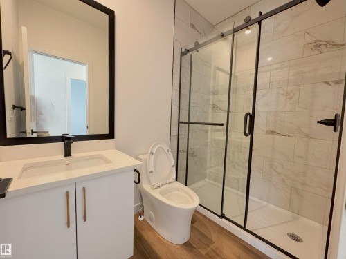 Bathroom featuring vanity, a stall shower, and light wood-style floors - 7 Tilia Place, Spruce Grove, AB - Indoor Photo Showing Bathroom
