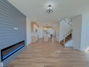 Unfurnished living room featuring light wood-style floors and recessed lighting - 7 Tilia Place, Spruce Grove, AB  - Indoor With Fireplace 