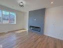 Unfurnished living room featuring a fireplace, light wood-style flooring, a textured ceiling, and recessed lighting - 7 Tilia Place, Spruce Grove, AB  - Indoor With Fireplace 