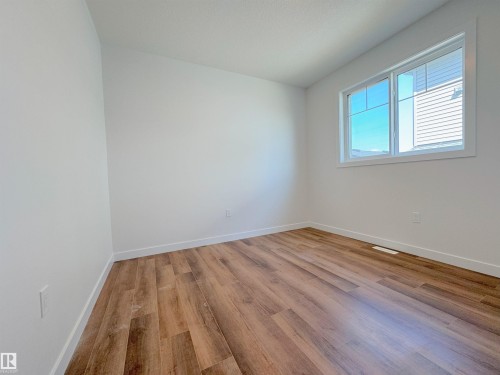 Empty room featuring light wood-type flooring and baseboards - 7 Tilia Place, Spruce Grove, AB - Indoor Photo Showing Other Room